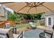 Backyard patio with comfortable seating arrangement and large umbrella perfect for outdoor relaxation at 1294 Parkview Nw Ln, Kennesaw, GA 30152