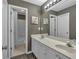 Well-lit bathroom featuring double sinks, white cabinets, and a shower-tub combo at 1294 Parkview Nw Ln, Kennesaw, GA 30152