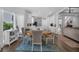 Bright dining area adjacent to the kitchen with hardwood floors and a charming table setting at 1294 Parkview Nw Ln, Kennesaw, GA 30152