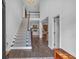 Inviting entryway with hardwood floors, a staircase, and views into the living room at 1294 Parkview Nw Ln, Kennesaw, GA 30152