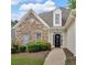 Charming single-story home featuring a stone facade, manicured landscaping, and a decorative front door at 1294 Parkview Nw Ln, Kennesaw, GA 30152
