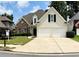 Charming two-story home with a stone facade, manicured lawn, and a two-car garage at 1294 Parkview Nw Ln, Kennesaw, GA 30152