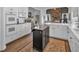 Spacious kitchen featuring stainless appliances and a stone fireplace visible from the living room at 1294 Parkview Nw Ln, Kennesaw, GA 30152