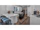 Well-lit kitchen featuring white cabinetry, breakfast bar, and a central kitchen island at 1294 Parkview Nw Ln, Kennesaw, GA 30152
