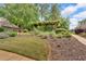 Beautifully landscaped backyard with an attractive pergola, lush foliage, and a walkway at 1294 Parkview Nw Ln, Kennesaw, GA 30152