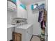 Functional laundry room with washer, dryer, and overhead storage cabinets at 1294 Parkview Nw Ln, Kennesaw, GA 30152