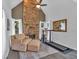 Bright living room featuring a stone fireplace and comfortable seating area with a treadmill at 1294 Parkview Nw Ln, Kennesaw, GA 30152
