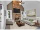 Cozy living room with stone fireplace, high ceilings, and neutral-toned furnishings for a relaxing atmosphere at 1294 Parkview Nw Ln, Kennesaw, GA 30152
