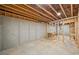 Unfinished basement with framed walls and concrete slab flooring at 210 Joe Green Ln, Canton, GA 30114