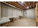 Unfinished basement features work tables and concrete slab floors at 210 Joe Green Ln, Canton, GA 30114