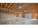 Unfinished basement with framed walls and two car garage doors at 210 Joe Green Ln, Canton, GA 30114