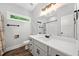 Bathroom with a large mirror, white vanity, framed window, and shower with black hardware at 210 Joe Green Ln, Canton, GA 30114