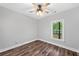 Bedroom features a ceiling fan, wood-look floors, light gray walls, and a large window at 210 Joe Green Ln, Canton, GA 30114
