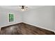 Light filled bedroom features a ceiling fan and wood-look flooring at 210 Joe Green Ln, Canton, GA 30114