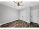 Clean bedroom offers hardwood floors, ceiling fan, and closet space at 210 Joe Green Ln, Canton, GA 30114