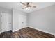 Bedroom features a ceiling fan, wood-look floors, light gray walls, and a double-door closet at 210 Joe Green Ln, Canton, GA 30114