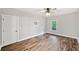 This bedroom features a window, ceiling fan, and wood-look floors at 210 Joe Green Ln, Canton, GA 30114