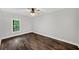 A bedroom with a window, ceiling fan, and beautiful wood floors at 210 Joe Green Ln, Canton, GA 30114