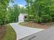 View of the home with a long concrete driveway leading up to an attached garage at 210 Joe Green Ln, Canton, GA 30114