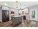 Stylish kitchen with grey cabinets, modern appliances, a center island and brick backsplash at 210 Joe Green Ln, Canton, GA 30114