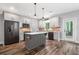 A spacious kitchen with stainless steel appliances, gray cabinets, island and brick backsplash at 210 Joe Green Ln, Canton, GA 30114