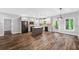 A spacious kitchen with stainless steel appliances, gray cabinets, island and brick backsplash at 210 Joe Green Ln, Canton, GA 30114
