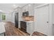 Well-equipped kitchen features stainless appliances, brick backsplash, and hardwood floors for a modern design at 210 Joe Green Ln, Canton, GA 30114