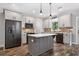Beautiful kitchen with grey cabinets, brick backsplash, center island and stainless steel appliances at 210 Joe Green Ln, Canton, GA 30114