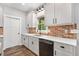 Modern kitchen with white cabinets, stainless steel appliances, quartz counters and stylish brick backsplash at 210 Joe Green Ln, Canton, GA 30114