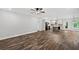 Open-concept living space featuring wood floors, a ceiling fan, and a view of the kitchen at 210 Joe Green Ln, Canton, GA 30114