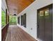 Side of house featuring a covered porch, wood flooring and an exterior door at 210 Joe Green Ln, Canton, GA 30114