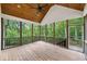 Inviting screened porch with wood flooring, ceiling fan, wood ceiling and view of the surrounding trees at 210 Joe Green Ln, Canton, GA 30114