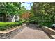 Beautiful courtyard with stone walls, pavers, lush landscaping, and mature trees creating a peaceful and inviting outdoor space at 2110 River Green Nw Dr # 2110, Atlanta, GA 30327