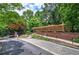 Gated community entrance with manicured landscaping and brick accents, ensuring privacy and security at 2110 River Green Nw Dr # 2110, Atlanta, GA 30327