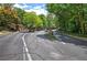 Gated community entrance with lush greenery and divided lanes, providing a secure and welcoming entry point at 2110 River Green Nw Dr # 2110, Atlanta, GA 30327
