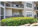 Exterior view of condo building with patios, black railings, and landscaping at 2110 River Green Nw Dr # 2110, Atlanta, GA 30327
