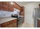 Well-lit kitchen features white backsplash, dark wood cabinets and stainless steel range at 2110 River Green Nw Dr # 2110, Atlanta, GA 30327