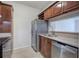 Kitchen featuring stainless steel refrigerator, dark wood cabinets, and stainless steel sink at 2110 River Green Nw Dr # 2110, Atlanta, GA 30327