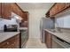 Traditional-style kitchen featuring wood cabinets, stainless steel appliances, and light countertops at 2110 River Green Nw Dr # 2110, Atlanta, GA 30327