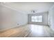 Bright living room with hardwood floors, crown molding, and a large window at 2110 River Green Nw Dr # 2110, Atlanta, GA 30327