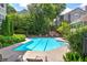 Community pool featuring lap lanes, lounge chairs, and beautiful landscaping at 2110 River Green Nw Dr # 2110, Atlanta, GA 30327