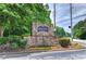 Community sign for The River West Condominiums surrounded by greenery at 2110 River Green Nw Dr # 2110, Atlanta, GA 30327