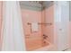 This retro pink bathroom includes a bathtub with shower, tiled walls, and updated fixtures for a fresh, clean feel at 6825 Castleton Dr, Atlanta, GA 30328