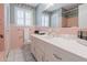 Charming bathroom features vintage pink tile, a white vanity, and a large mirror, blending retro style with functionality at 6825 Castleton Dr, Atlanta, GA 30328