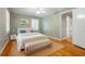 Cozy bedroom featuring hardwood floors, a comfortable bed, and an ensuite bathroom for added convenience and privacy at 6825 Castleton Dr, Atlanta, GA 30328