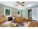 Well-lit bedroom featuring hardwood floors, a ceiling fan, and a large closet for ample storage and comfort at 6825 Castleton Dr, Atlanta, GA 30328