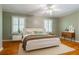 Bright bedroom with neutral walls, hardwood floors, modern furniture, and a comfortable queen-sized bed for a relaxing retreat at 6825 Castleton Dr, Atlanta, GA 30328