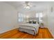 This cozy bedroom features hardwood floors, neutral walls, and shuttered windows for ample natural light at 6825 Castleton Dr, Atlanta, GA 30328