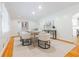 Bright dining room featuring hardwood floors, white walls and modern neutral furniture at 6825 Castleton Dr, Atlanta, GA 30328
