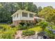 Charming two-story home featuring brick and siding exterior, surrounded by lush landscaping and mature trees at 6825 Castleton Dr, Atlanta, GA 30328